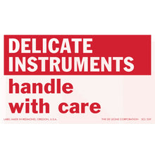 Red and white warning label for delicate instruments.