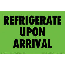 Green shipping label with black text reading ’REFRIGERATE UPON ARRIVAL’