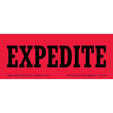 Red label with black text reading ’EXPEDITE’