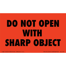 Red warning label with black text reading ’DO NOT OPEN WITH SHARP OBJECT’