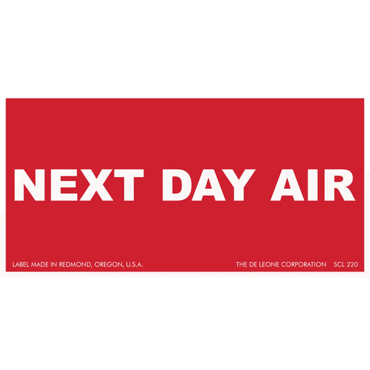 Red shipping label with white text reading ’NEXT DAY AIR’