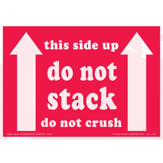Red warning label with white text reading ’this side up do not stack do not crush’ and upward-pointing arrows.