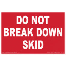 Red warning sign with white text reading ’DO NOT BREAK DOWN SKID’