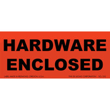 Red warning label with black text reading ’HARDWARE ENCLOSED’