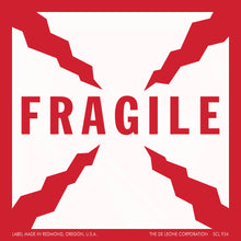 Red and white ’FRAGILE’ warning label with angular corner designs.