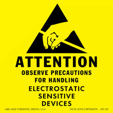 Warning label for electrostatic-sensitive device handling with a black triangle symbol on yellow background.