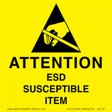 Warning sign for electrostatic discharge (ESD) sensitive items featuring a black triangle with a hand and electronic component symbol on yellow background.