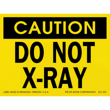 Yellow and black warning sign stating ’CAUTION DO NOT X-RAY’