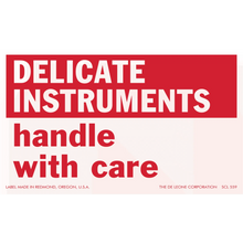 Red and white warning label for delicate instruments.