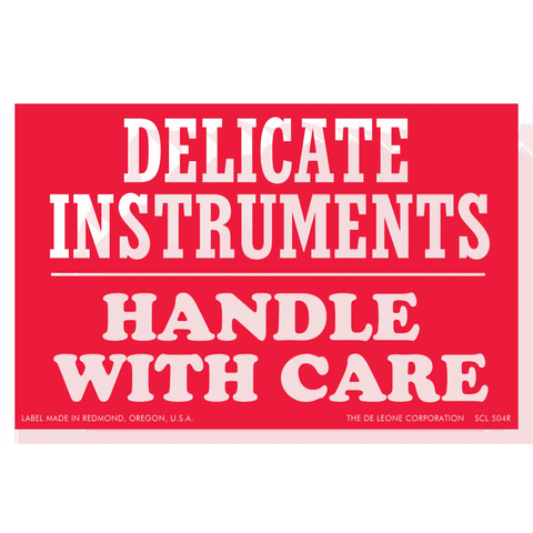 Red warning label with white text reading ’DELICATE INSTRUMENTS HANDLE WITH CARE’