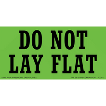 Green warning label with black text reading ’DO NOT LAY FLAT’