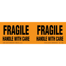 Orange warning label with black text reading ’FRAGILE HANDLE WITH CARE’ repeated twice.