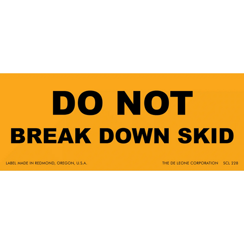 Orange warning label with black text reading ’DO NOT BREAK DOWN SKID’