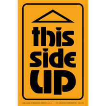 Black text reading ’THIS SIDE UP’ on an orange warning label.