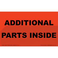 Red shipping label with black text reading ’ADDITIONAL PARTS INSIDE’