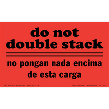 Red warning label with black text in English and Spanish that says ’do not double stack’/’no pongan nada encima de esta carga’