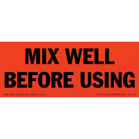 Red warning label with black text that reads ’MIX WELL BEFORE USING’