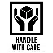 Black and white ’Handle with Care’ shipping symbol showing hands holding a cube.