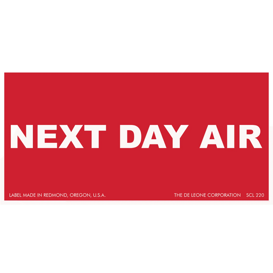 Red shipping label with white text reading ’NEXT DAY AIR’