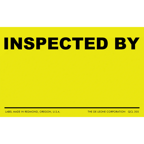 Yellow inspection label with black text reading ’INSPECTED BY’ and a blank line below.