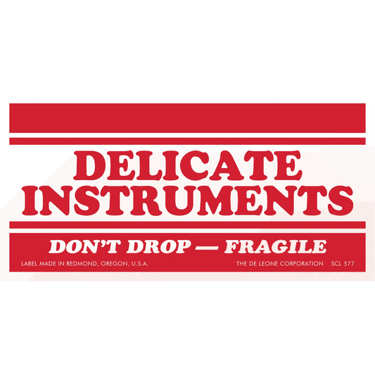 Red and white warning label for delicate instruments marked as fragile.