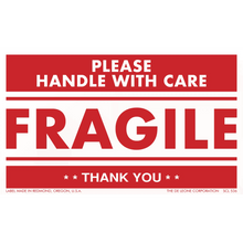 Red and white ’FRAGILE - PLEASE HANDLE WITH CARE’ shipping label.