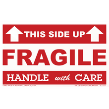 Red and white ’FRAGILE - HANDLE WITH CARE’ shipping label with ’THIS SIDE UP’ arrows.