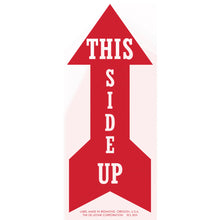 Red arrow-shaped sign with white text reading ’THIS SIDE UP’