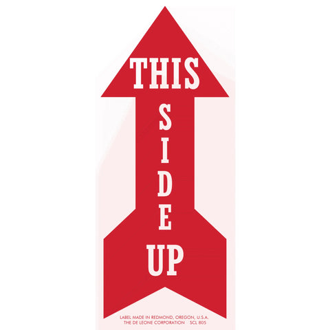 Red arrow-shaped sign with white text reading ’THIS SIDE UP’