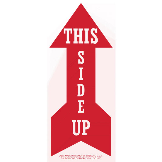 Red arrow-shaped sign with white text reading ’THIS SIDE UP’