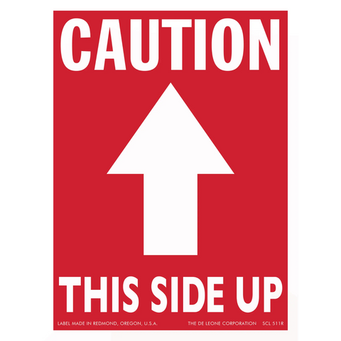 Red caution sign with white arrow pointing upward and text reading ’THIS SIDE UP’