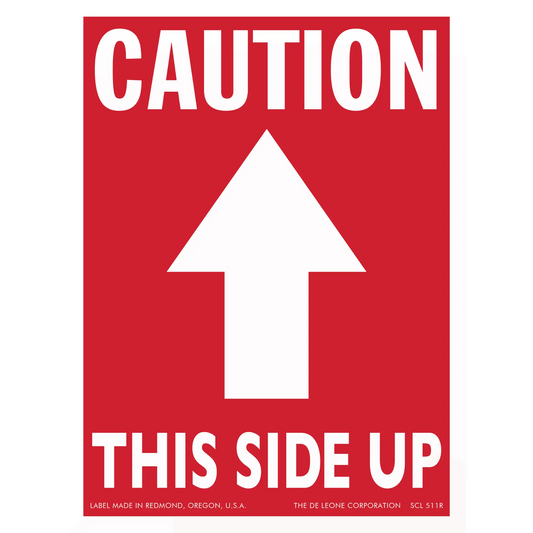 Red caution sign with white arrow pointing upward and text reading ’THIS SIDE UP’