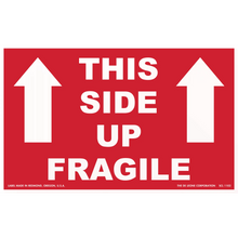 Red shipping label with white text reading ’THIS SIDE UP FRAGILE’ and upward-pointing arrows.