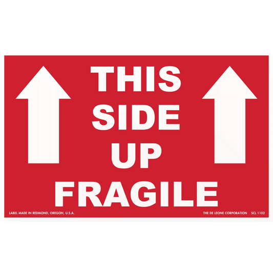 Red shipping label with white text reading ’THIS SIDE UP FRAGILE’ and upward-pointing arrows.