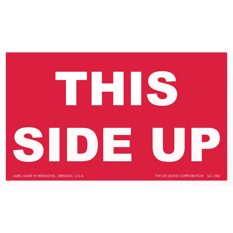 Red shipping label with white text reading ’THIS SIDE UP’