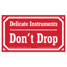 Red warning label stating ’Delicate Instruments Don’t Drop’