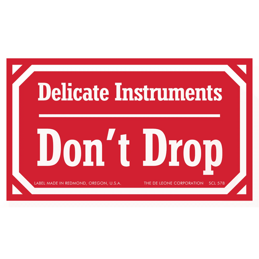 Red warning label stating ’Delicate Instruments Don’t Drop’