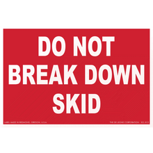 Red warning sign with white text reading ’DO NOT BREAK DOWN SKID’