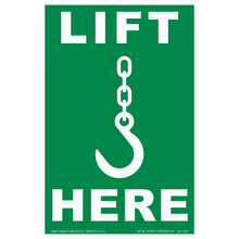 Green safety sign showing a crane hook symbol with ’LIFT HERE’ text.