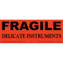 Red warning label with black text reading ’FRAGILE DELICATE INSTRUMENTS’