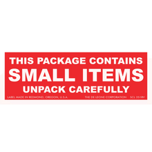 Red warning label with white text stating ’THIS PACKAGE CONTAINS SMALL ITEMS UNPACK CAREFULLY’