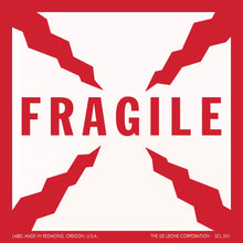 Red and white ’FRAGILE’ warning label with jagged corner designs.