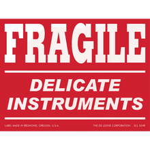 Red warning label with white text reading ’FRAGILE DELICATE INSTRUMENTS’