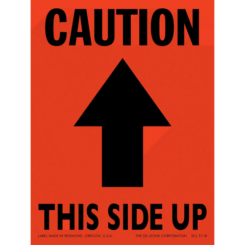 Orange caution sign with black arrow pointing upward and text reading ’THIS SIDE UP’