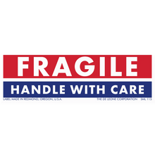 Red and blue ’FRAGILE - HANDLE WITH CARE’ shipping label from The De Leone Corporation in Redmond, Oregon.