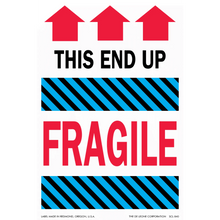 Shipping label with red arrows pointing upward and the text ’THIS END UP’ and ’FRAGILE’ separated by blue striped bands.